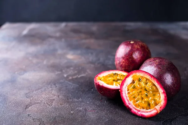 Passion fruits on dark table — Stock Photo, Image