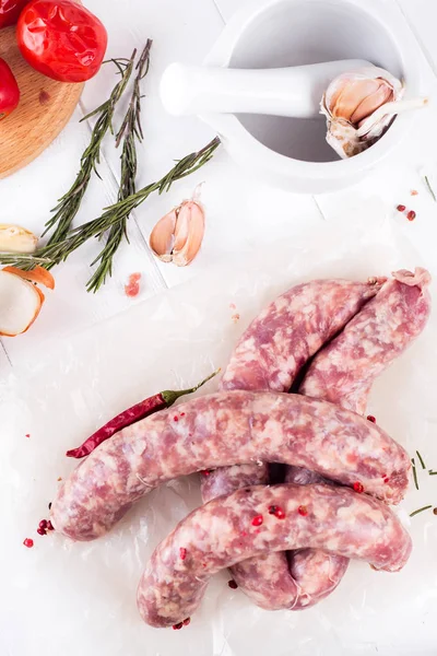 Raw sausages on slate — Stock Photo, Image