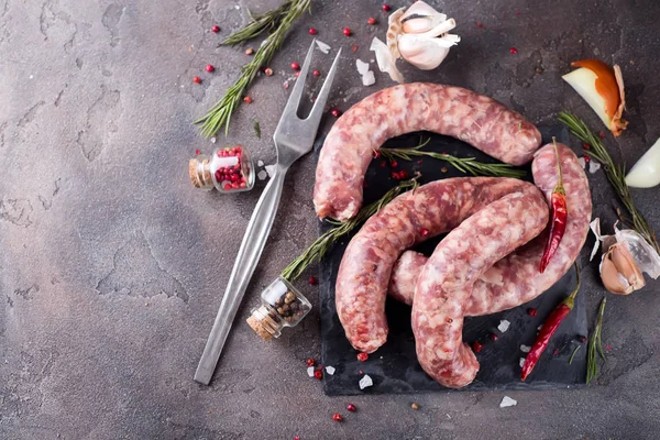 Raw sausages with spice — Stock Photo, Image