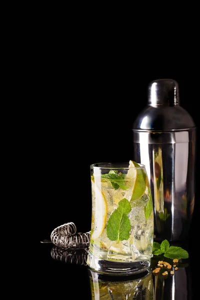 Glass of a cold cocktail drink with tonic served with brown sugar and shaker — Stock Photo, Image