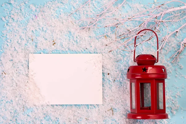 Hoja de papel blanco y linterna roja de Navidad en la nieve y el fondo azul — Foto de Stock