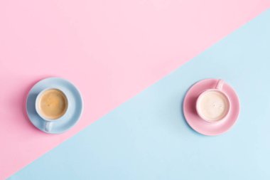 Yaratıcı pastel mavi arka plan ve iki seramik bardak taze demlenmiş kahve.