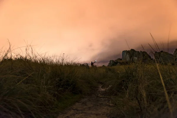 Hombre con linterna en la noche en las montañas — Foto de Stock