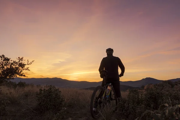 El ciclista en la montaña al atardecer — Foto de Stock