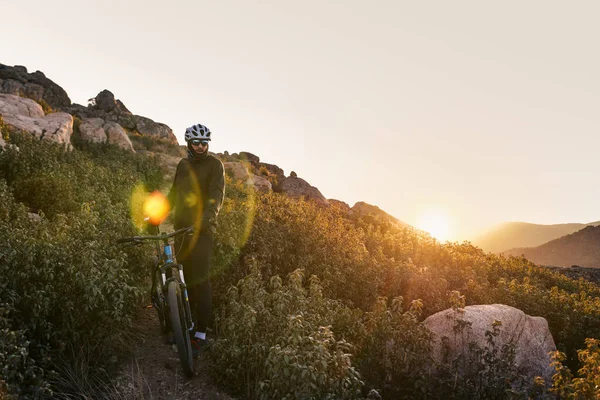 El ciclista en la montaña al atardecer — Foto de Stock