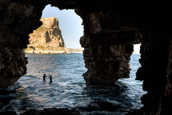 Silhuetten av en man som dykning i vatten, Visa från en grotta — Stockfoto