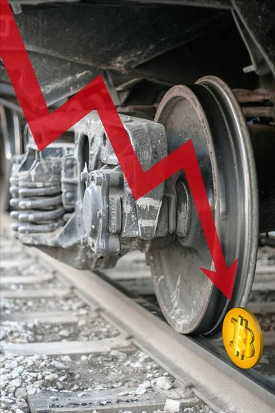Red down arrow and bitcoin on rails under a train wheel. Bitcoin is crushed and fell down. Cryptocurrency trading crisis. Crash BTC. Vertical.