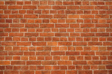 tuğla kırmızı duvar. Eski bir tuğla evin arka planı.