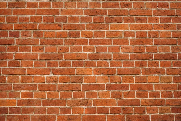tuğla kırmızı duvar. Eski bir tuğla evin arka planı.