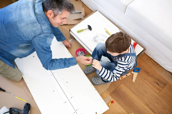 Father and son assembling furniture — Stock Photo, Image