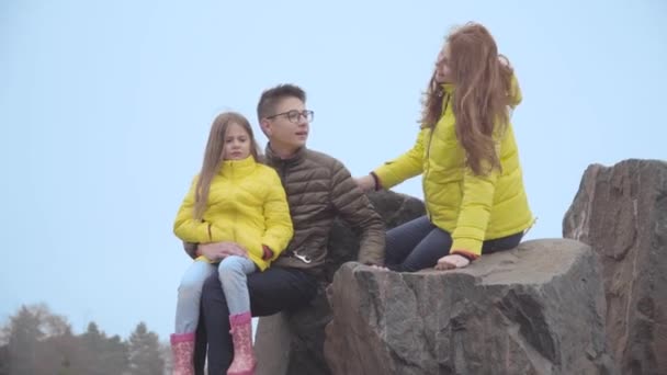 Brother Sister Talking Young Mother Sitting Rocks Autumn Park Black — Stock Video