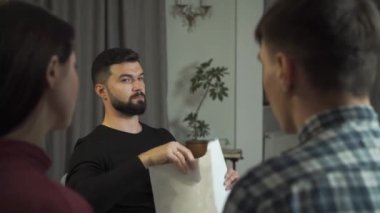 Siyah saçlı yakışıklı beyaz erkek psikolog hastalara Rorschach mürekkep lekeleri gösteriyor. Profesyonel psikanalist, çift ya da aileyi analiz ediyor. Çift terapisi, psikolojik analiz..
