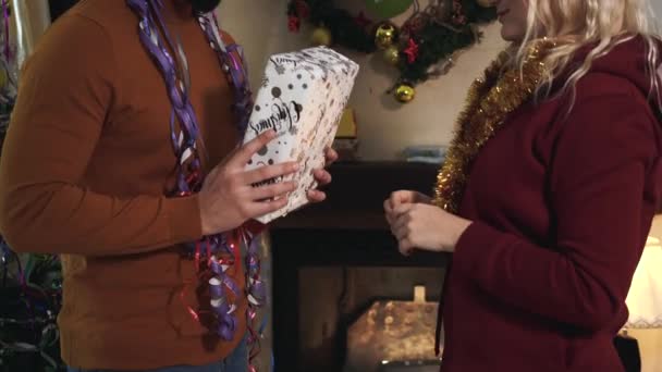 Unrecognizable Caucasian man giving Christmas gift to young blond woman. Husband making surprise present for lovely wife on New Years eve. Celebration, holidays season. — Stock Video