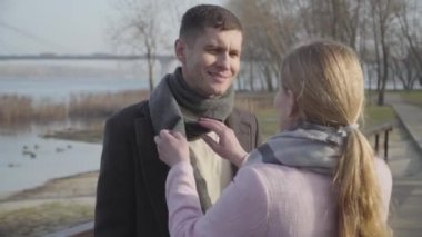 Açık havada erkek atkısı tamir eden, tanınmayan sarışın, beyaz bir kadının yakın çekimi. Şehir parkında sevimli eşiyle konuşan mutlu genç bir adam. Aşk, sevgi, yaşam tarzı..