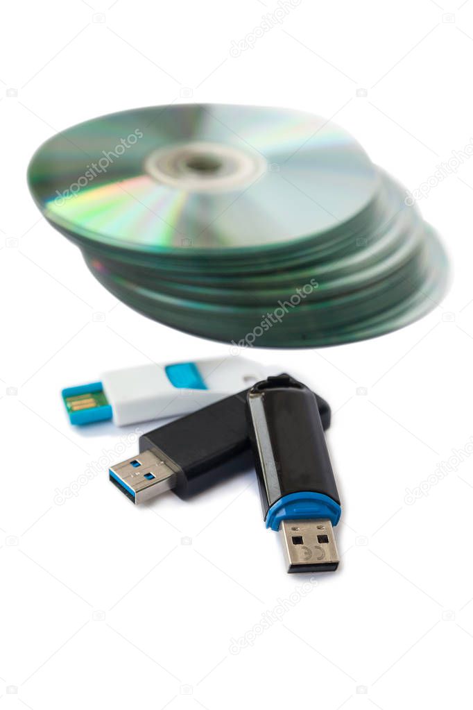 Usb flash drives and CDs isolate on white background.