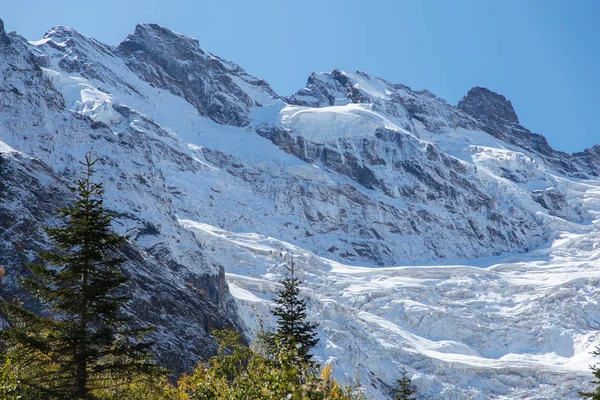 Dombay mountains, trekking in national park to the Alibek waterfall and glacier, autumn landscape