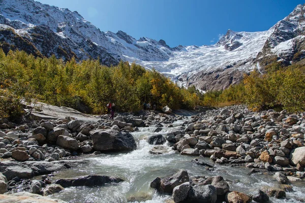 Dombay mountains, trekking in national park to the Alibek waterfall and glacier, autumn landscape