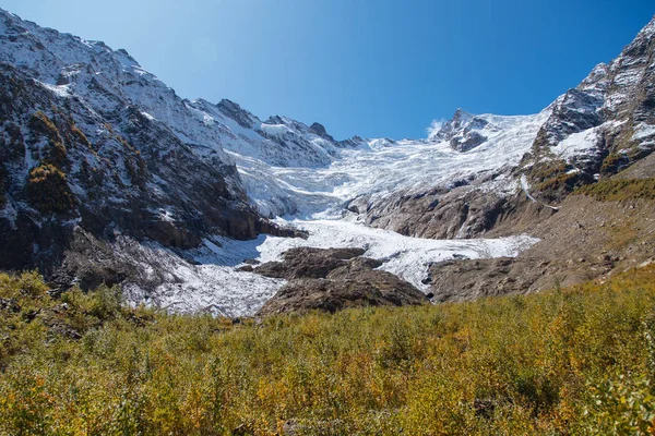 Dombay mountains, trekking in national park to the Alibek waterfall and glacier, autumn landscape