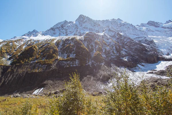 Dombay mountains, trekking in national park to the Alibek waterfall and glacier, autumn landscape