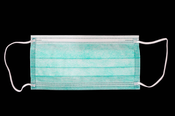 Surgical mask on a black background