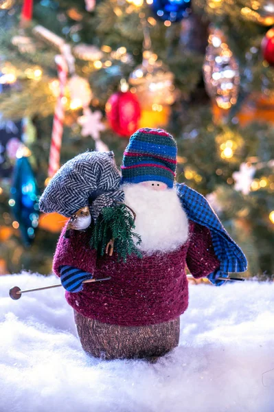 Santa doll on skis with bag of toys — Stock Photo, Image