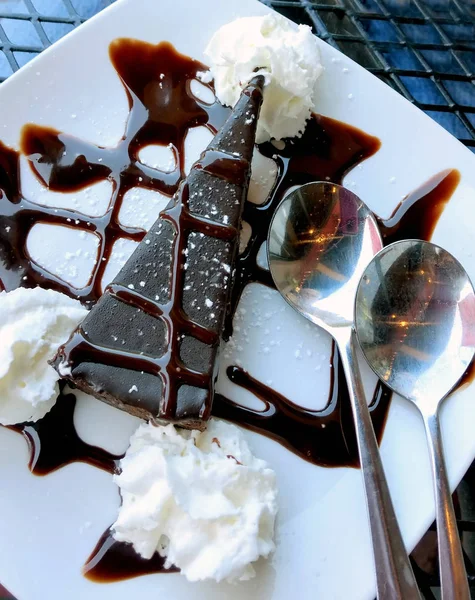 Flour-less chocolate cake with chocolate sauce and whipped cream
