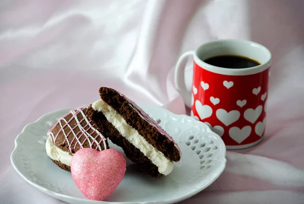 Pastry with mug of coffee and a pink heart — Stock Photo, Image
