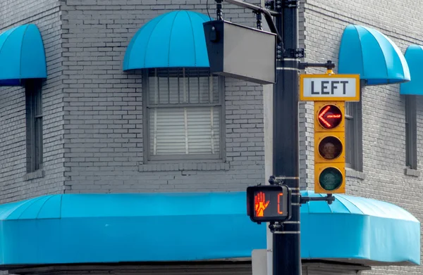 Stop light says no left turn and no walking