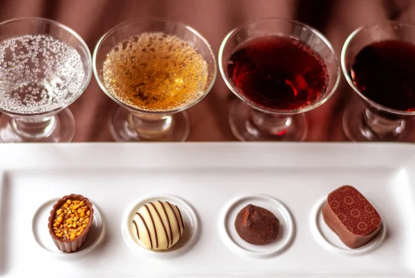 Small tastes of different wines from sparkling to dessert wine, are set out to try with fancy chocolates