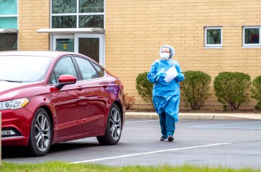 Benton Harbor MI USA 23 Nisan 2020. Korona virüsü kapmış olabilecek bilinmeyen bir hastayı test etmek için cesur bir tıp çalışanı bu test alanından geçiyor.