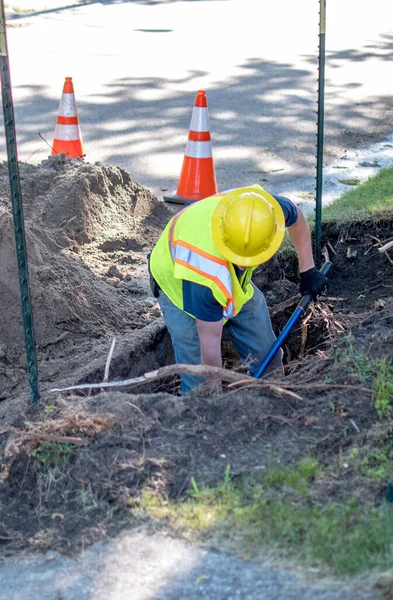 Arbeiter Gräbt Ein Vergrabenes Kabel Außerhalb Eines Stadthauses Erreichen Damit — Stockfoto