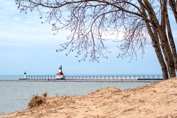 The walkway and beach near the St Joseph light house sits empty on a warm spring day, as the whole state stays home under lock down orders