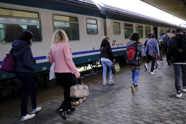 Yolcular, 28 Ekim 2019 'da İtalya' nın Siena kentindeki merkez tren istasyonuna bir banliyö treni geldikten sonra platformda yürürler.