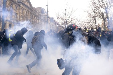 Protesters clash with French riot police during a demonstration against pension reforms in Paris, France, 05 December 2019.  clipart