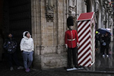 People walk between mannequins of Britain's honour guards displayed to celebrate the friendship between Belgium and Britain at Brussels' Grand Place, Belgium January 30, 2020. clipart