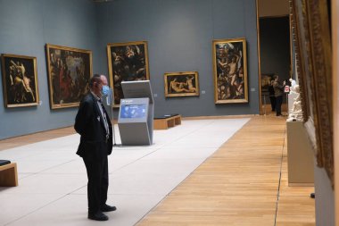 Security guards walk in the  the Royal Museum of Fine Arts at the first day of reopening amid the coronavirus crisis in Brussels, Belgium, 19 May 2020. clipart