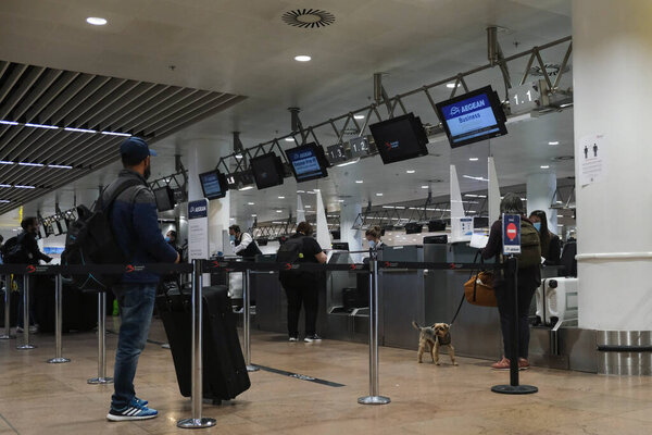 Passengers, wearing mouth masks to protect against the spread of coronavirus, wait in line for check-in, in their way to Athens, at the Brussels International Airport in Brussels, , May 15, 2020.