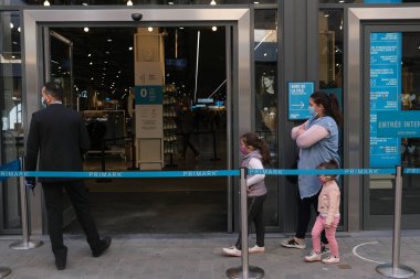 Müşteriler 11 Mayıs 2020 'de Brüksel, Belçika' nın ana ticari caddesi Neuve sokağındaki dükkanlara girmek için kuyruğa girdiler. Yetkililer, 11 Mayıs itibarıyla gereksiz mağazaların kapılarını müşterilere açmasına izin verdiler.. 