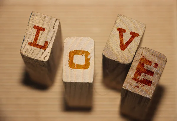 Love word on wooden blocks. Love romance devotion concept.