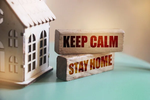 keep calm stay home on wooden blocks. Corona virus prevention pandemic behaviour concept.