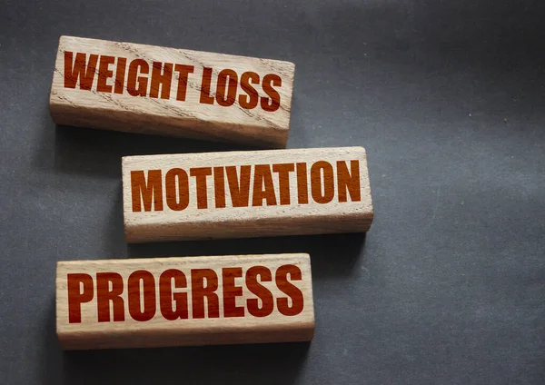 Weight loss motivation progress words on wooden blocks with copyspace. Successful diet plan healthy food weightloss concept