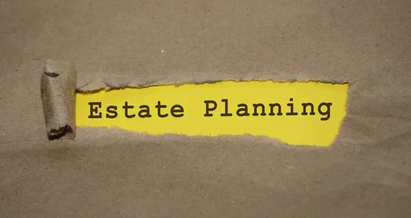 Estate Planning words under brown torn paper. Real Estate investment business concept.