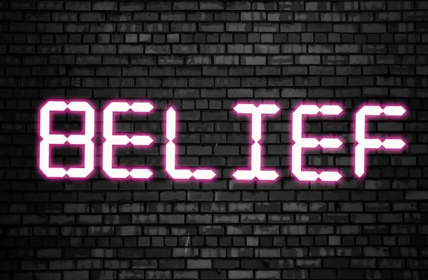 Belief word glowing in neon pink on black brick wall. Believes and statements, personal coaching and achievements concept