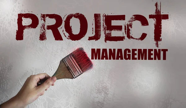 Project Management message and paintbrush in hand. Business tartup management concept.