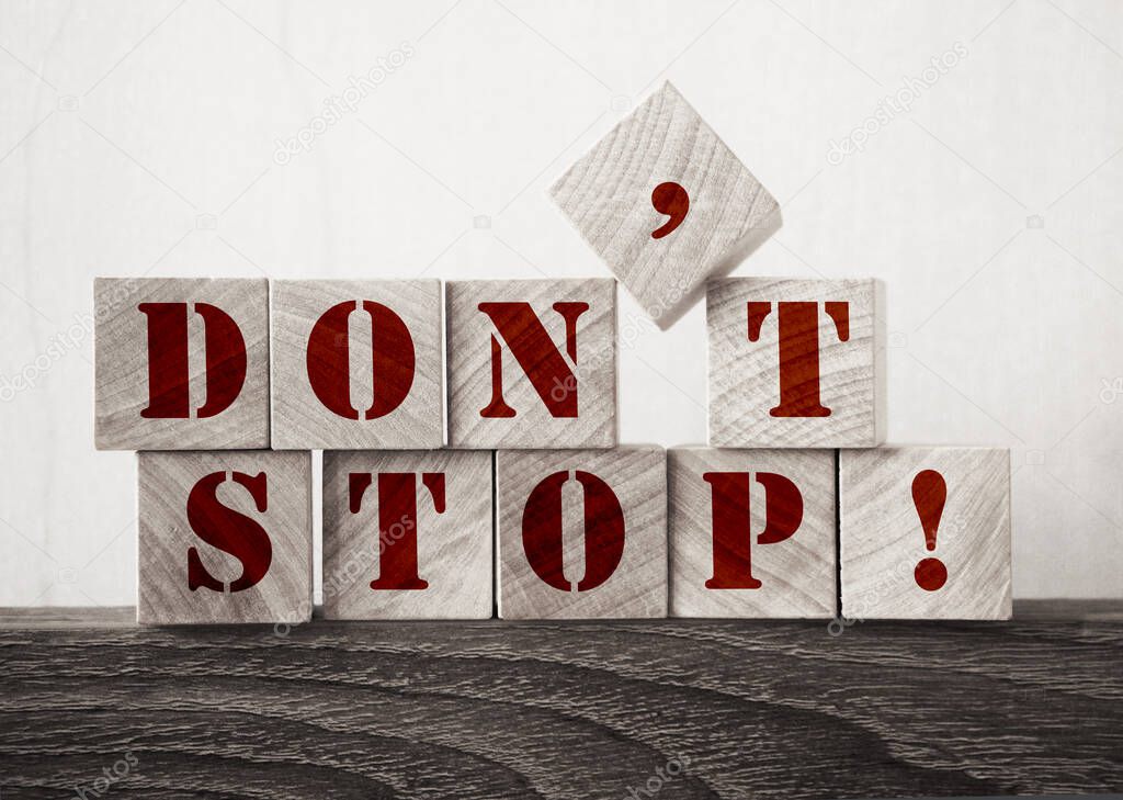 Don't Stop written on a wooden cubes. Business startup motivation encouraging concept.