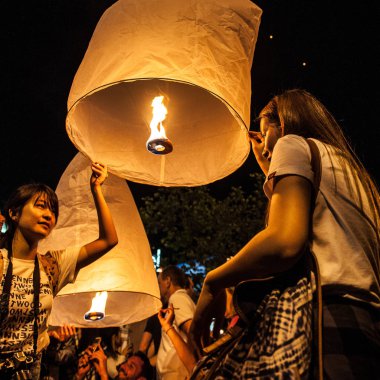 Chiang Mai, Tayland - 31 Aralık 2017: Kalabalıklar halinde gökyüzü fenerleri, uçan fenerler, yüzen fenerler, karanlık gece gökyüzünde ay ışığında sıcak hava balonları fırlatıyorlar. Yeni yıl ve Tayland 'da Yeepeng festivali. Chiang Mai, Kuzey Tayland.