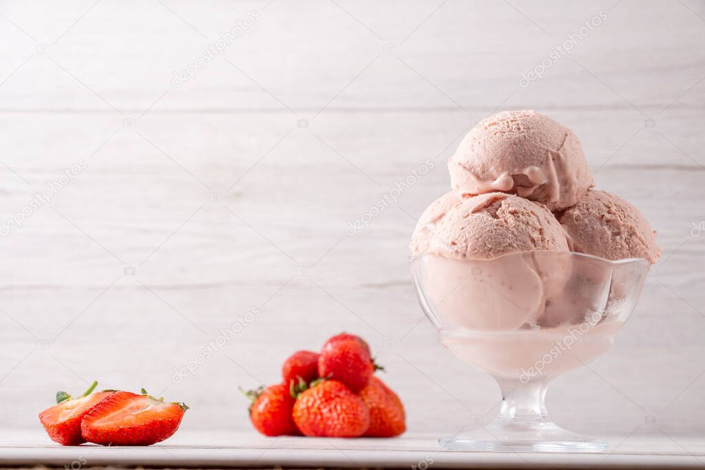 Strawberry ice cream in a flask on a light background