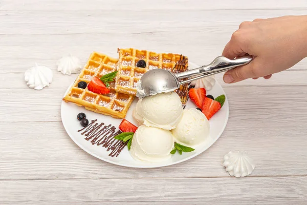 Putting a scoop of ice cream on a plate