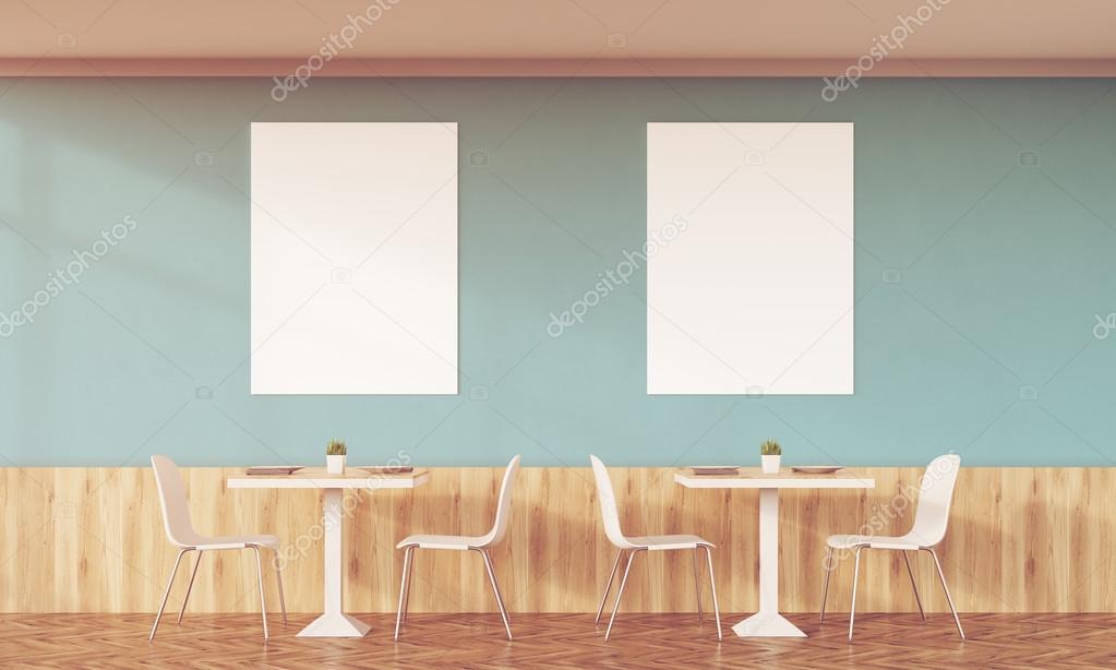 Sunlit family cafe with two posters and green walls