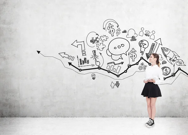 Girl in short skirt near wall with sketches — Stock Photo, Image